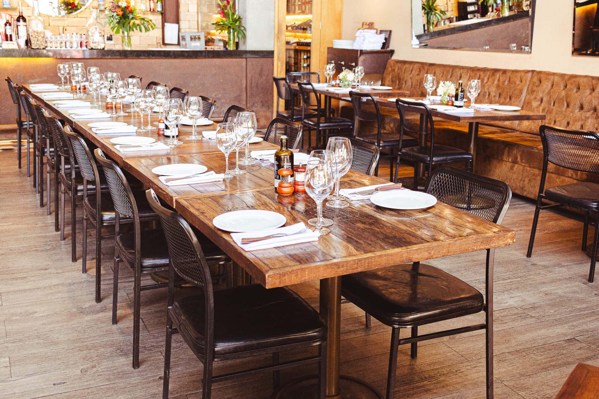 foto mostra ambiente interno do restaurante fogo steakhouse com mesas grandes e cadeiras no estilo industrial
